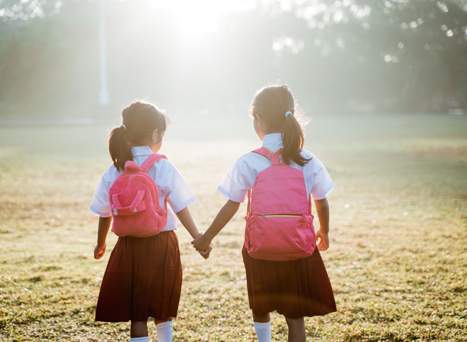 Back to school two little girls walking hand in hand
