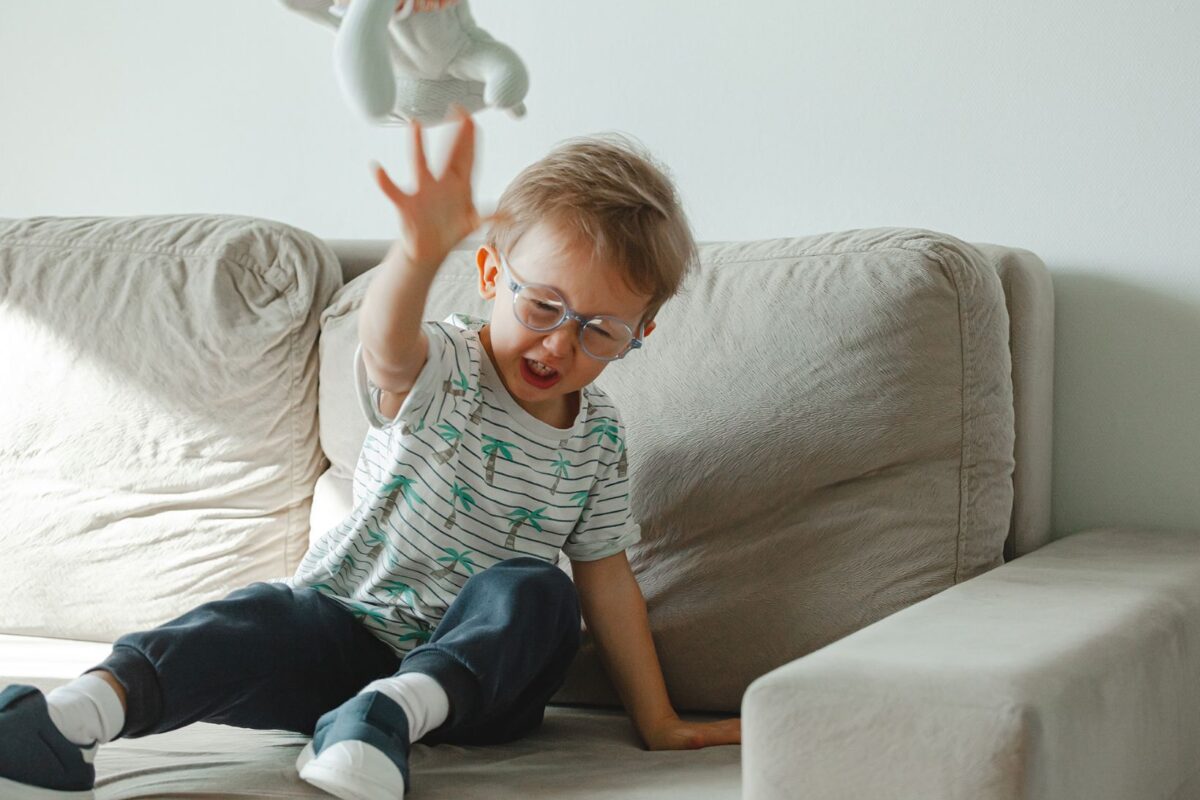Emotional regulation - understanding dysreglated child. Child throwing a toy when displeased.