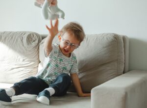 Emotional regulation - understanding dysreglated child. Child throwing a toy when displeased.