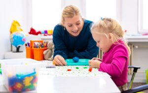 A child therapist helping a child through play therapy