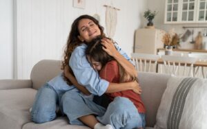 Mum hugging teenage daughter