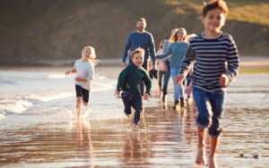 Happy family running on the beach